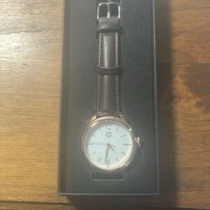 Gold tone watch with brown leather strap